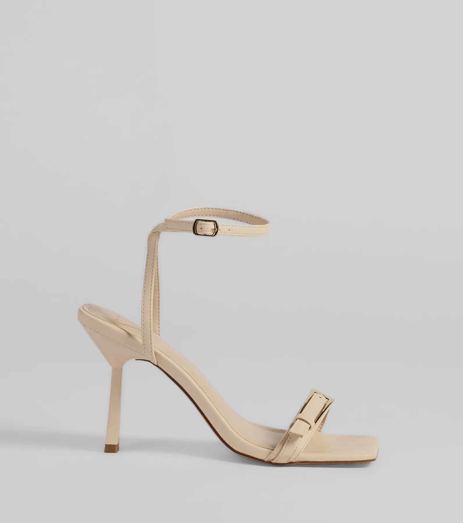 Elevate warm-weather looks with Buckled Up Stiletto Heels in ivory, a pair of trendy sandals bringing chic, modern flair to every step.