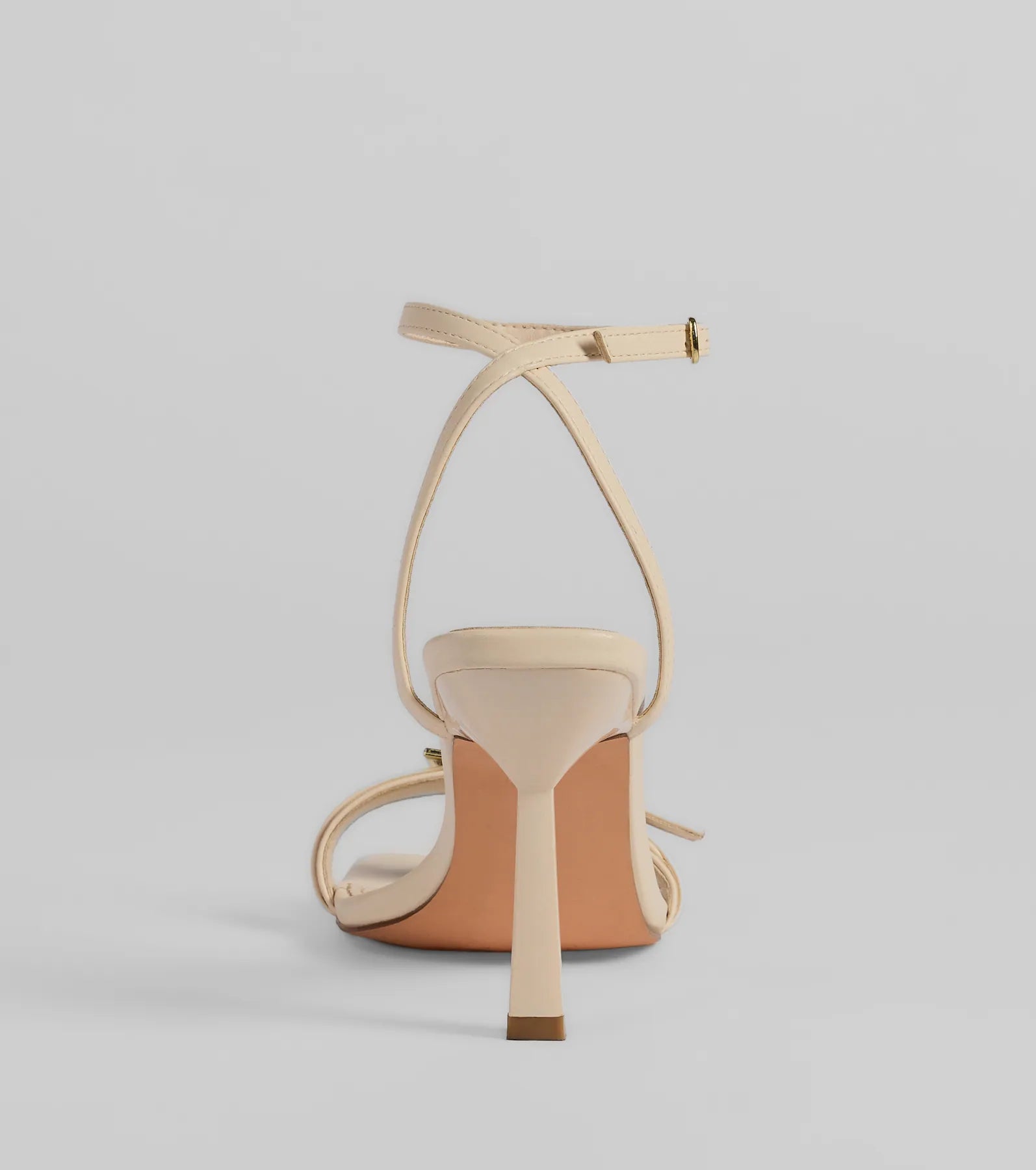 Elevate warm-weather looks with Buckled Up Stiletto Heels in ivory, a pair of trendy sandals bringing chic, modern flair to every step.