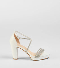 Elevate warm-weather looks with Night Shimmer Rhinestone Platform Block Heels in white, a pair of trendy sandals bringing chic, modern flair to every step.