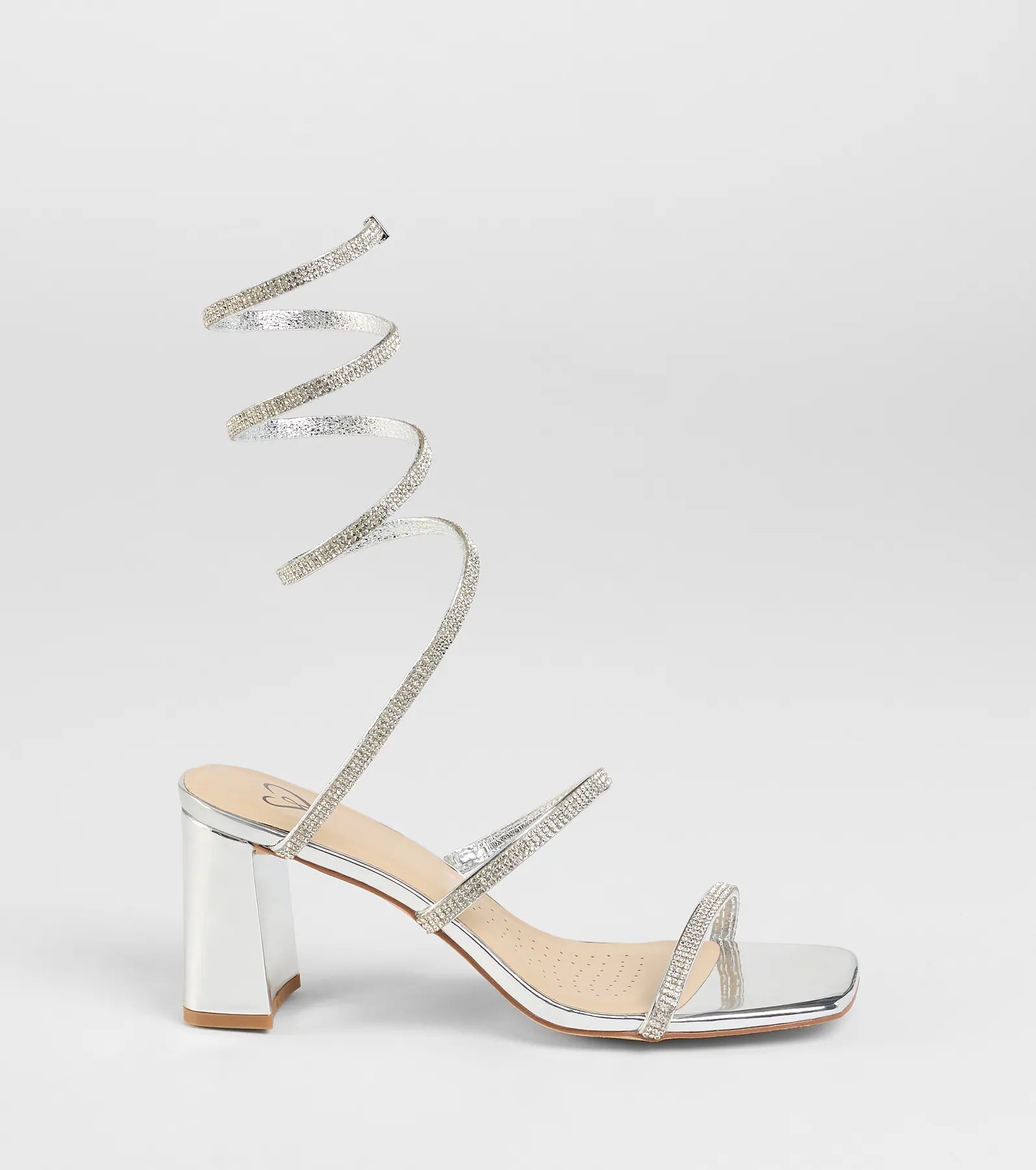 Elevate warm-weather looks with Sparkle And Shine Rhinestone Spiral Block Heels in silver, a pair of trendy sandals bringing chic, modern flair to every step.