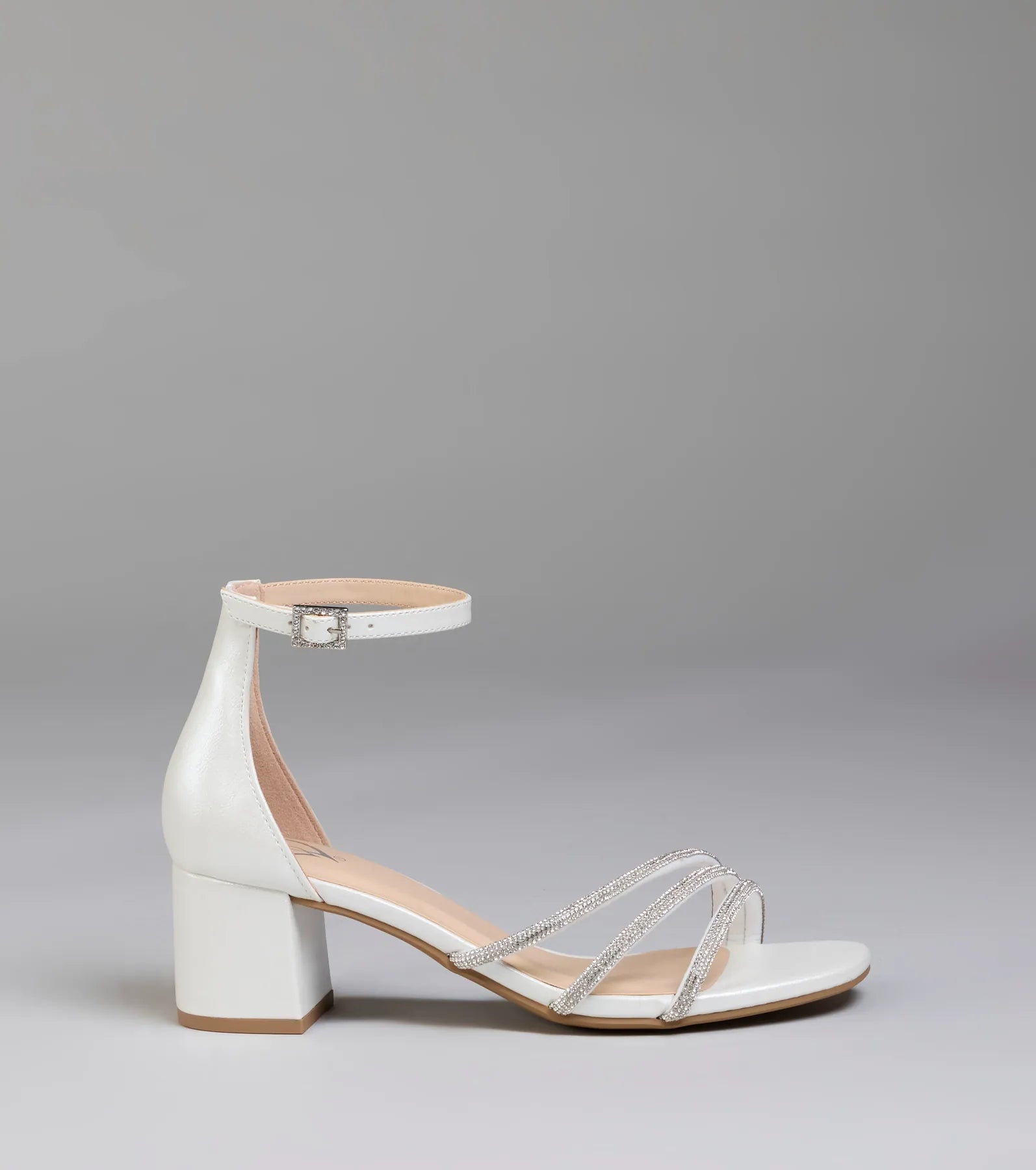 Elevate warm-weather looks with Ultra Luxe Rhinestone Short Block Heels in pearl, a pair of trendy sandals bringing chic, modern flair to every step.