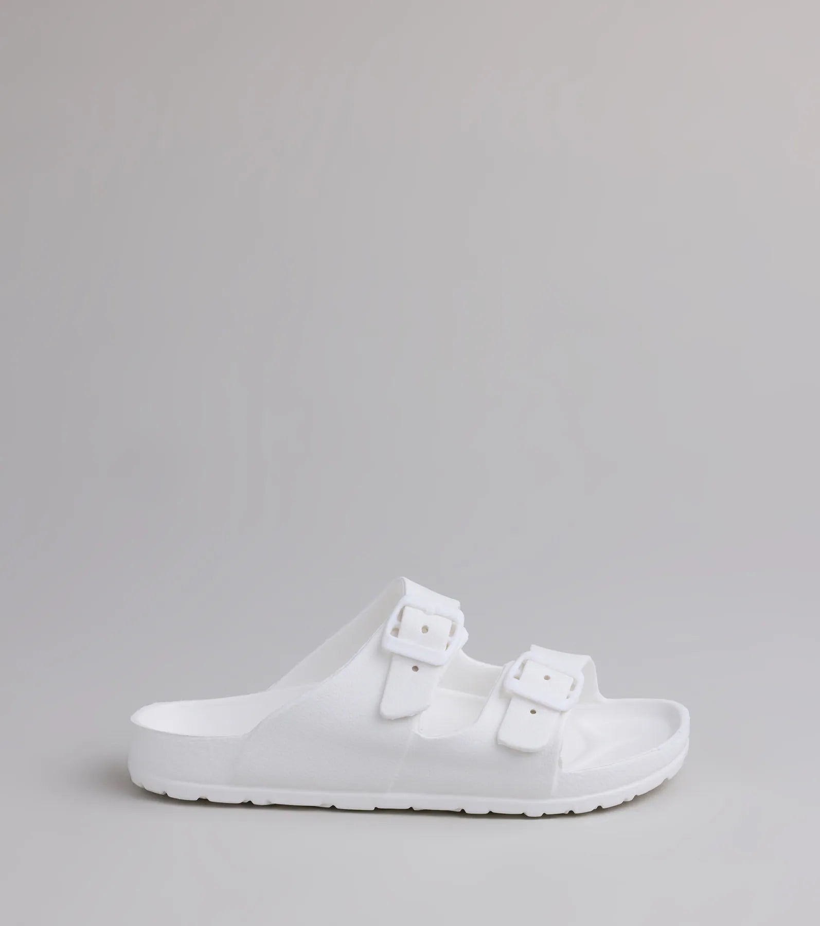 Style made simple with the Tag Along Strappy Buckle Sandals in white, trendy women’s shoes that take your outfit from basic to bold in one step.