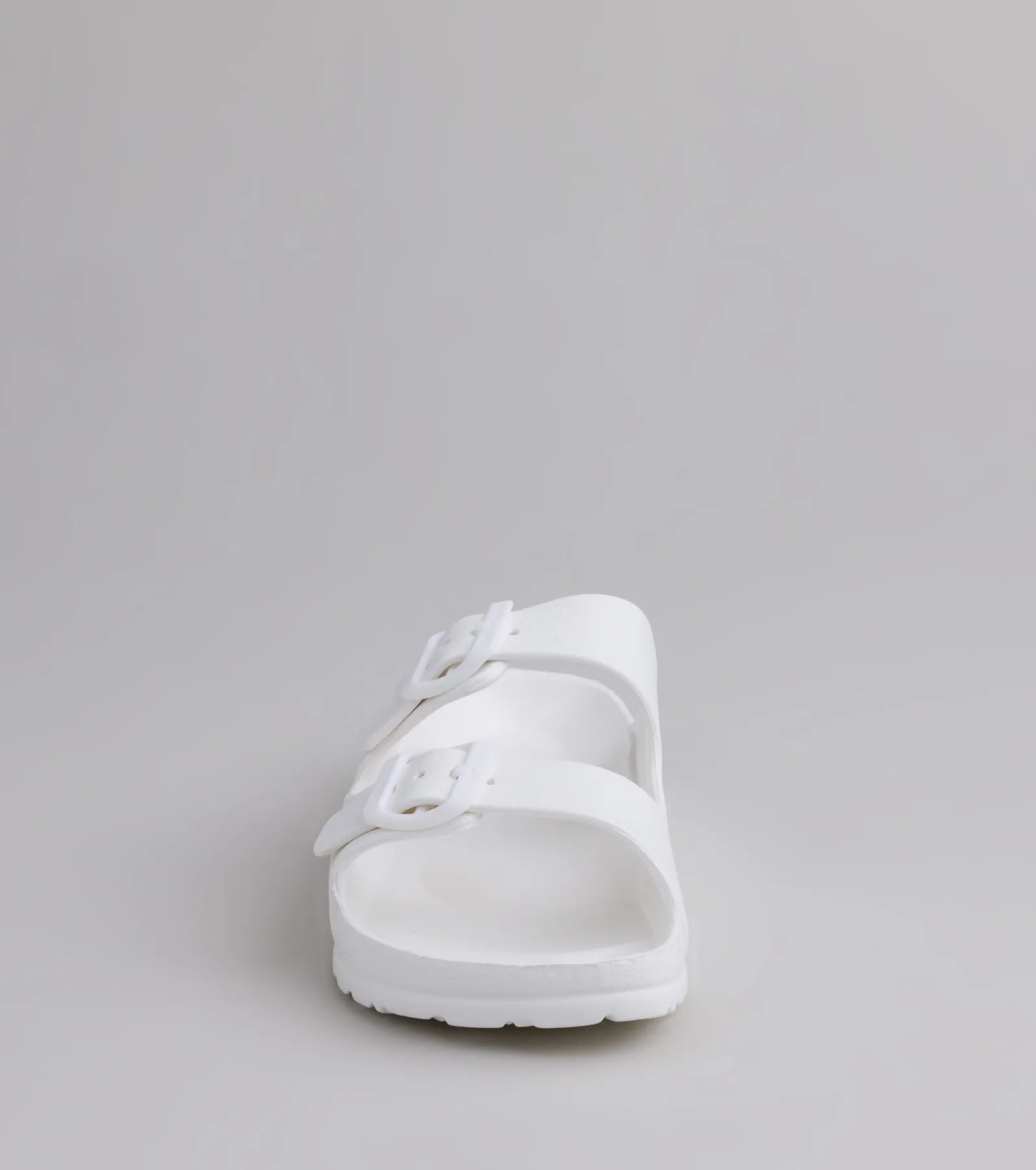 Style made simple with the Tag Along Strappy Buckle Sandals in white, trendy women’s shoes that take your outfit from basic to bold in one step.