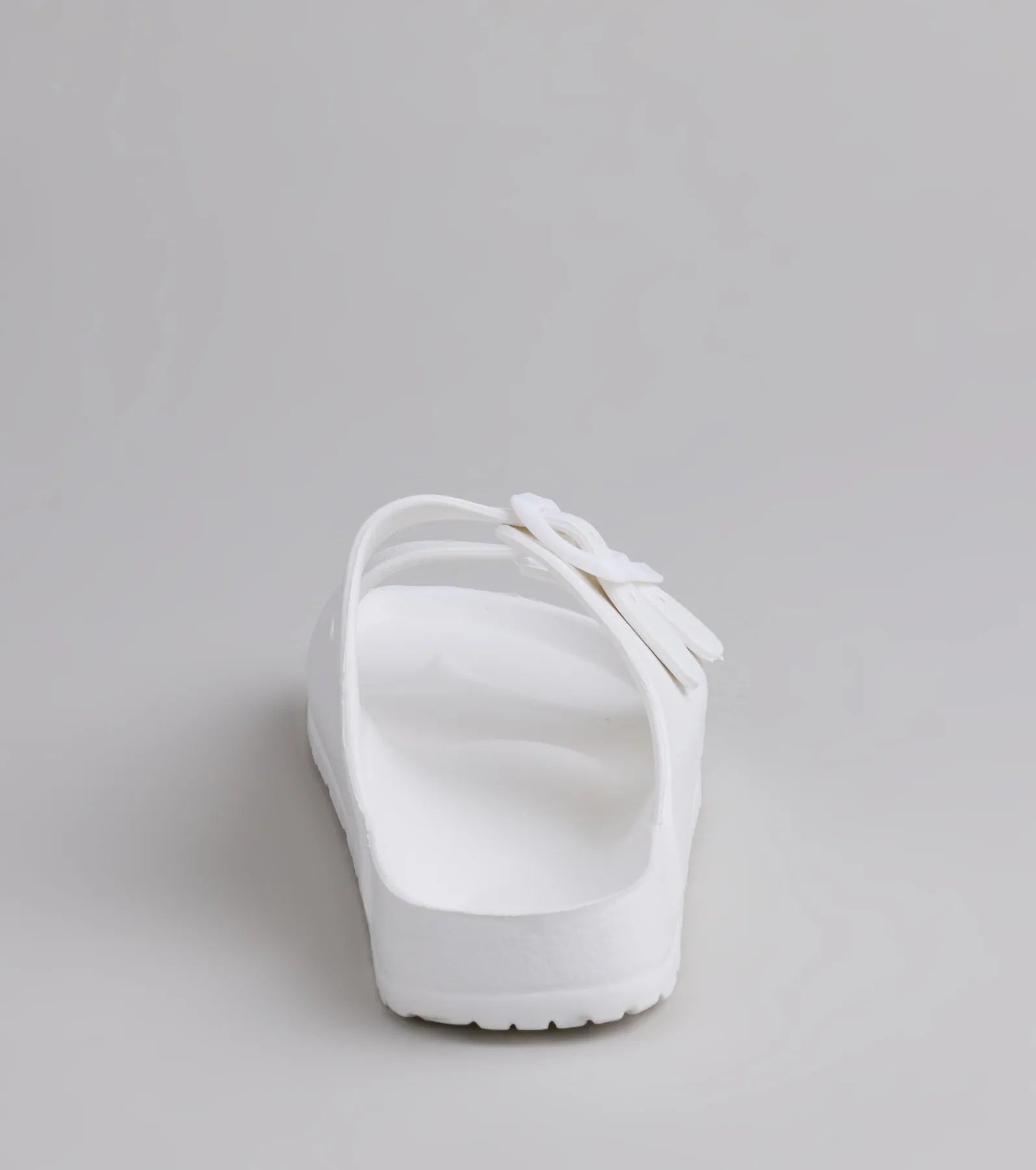 Style made simple with the Tag Along Strappy Buckle Sandals in white, trendy women’s shoes that take your outfit from basic to bold in one step.