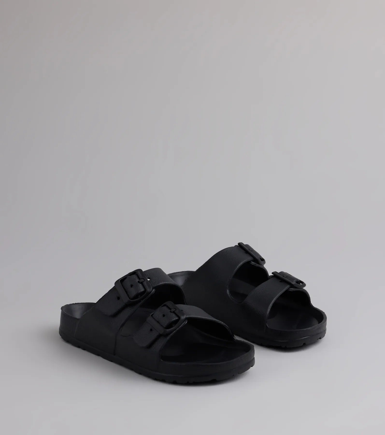 Style made simple with the Tag Along Strappy Buckle Sandals in black, trendy women’s shoes that take your outfit from basic to bold in one step.