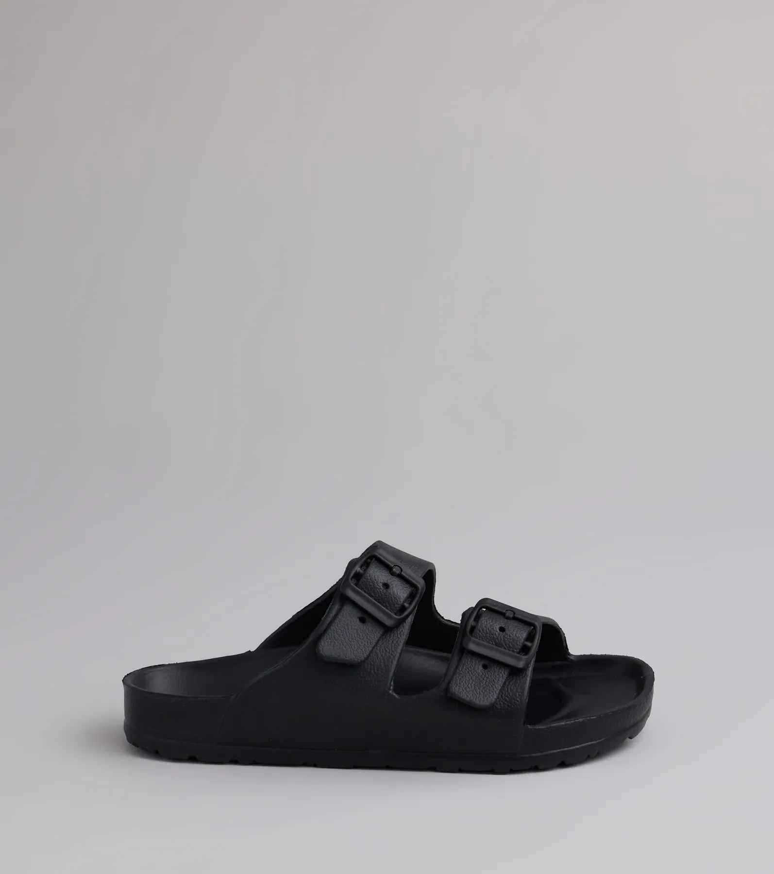Style made simple with the Tag Along Strappy Buckle Sandals in black, trendy women’s shoes that take your outfit from basic to bold in one step.