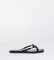 Elevate warm-weather looks with Dainty Looks Bow Thong Sandals in black, a pair of trendy sandals bringing chic, modern flair to every step.