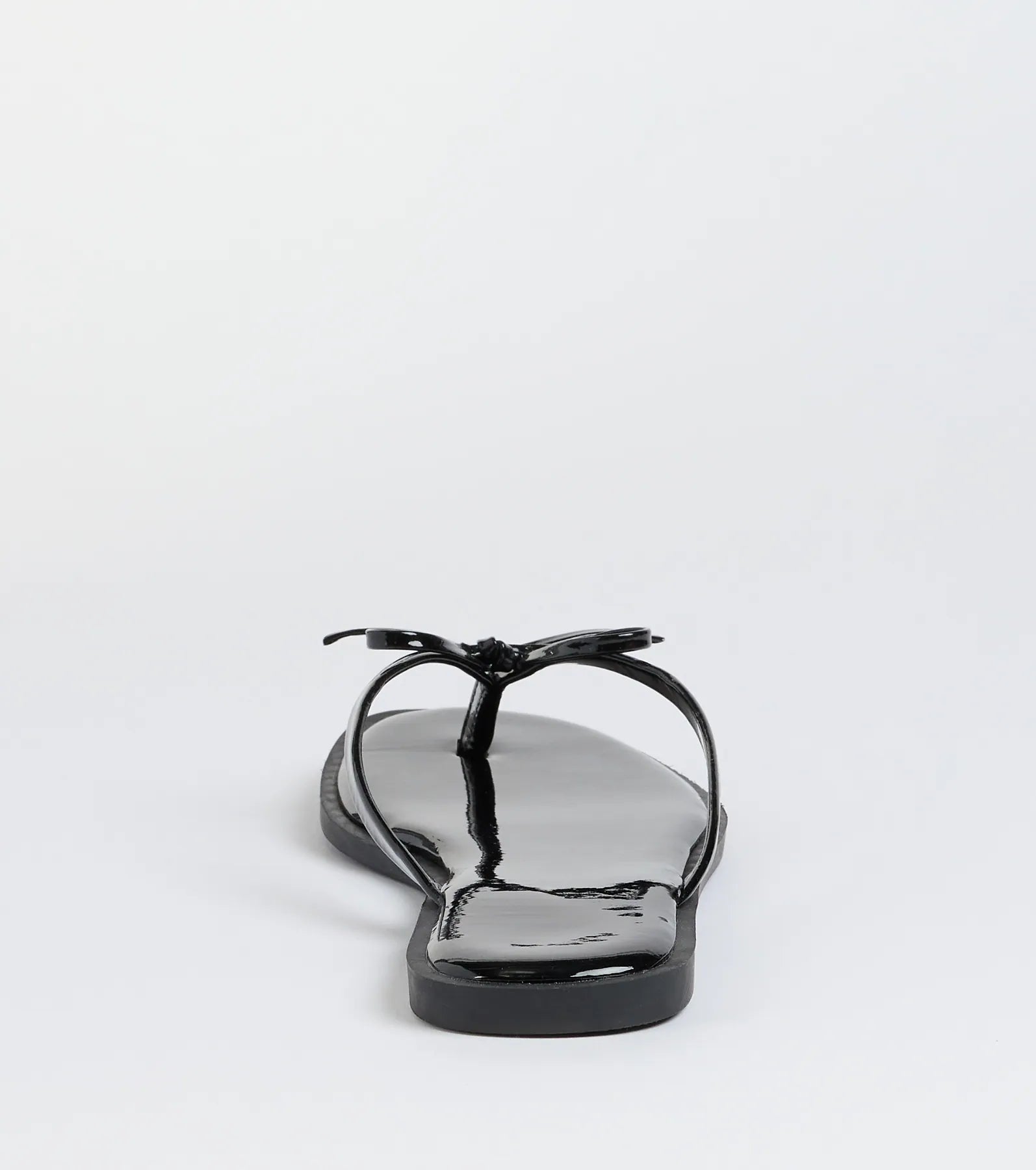 Elevate warm-weather looks with Dainty Looks Bow Thong Sandals in black, a pair of trendy sandals bringing chic, modern flair to every step.