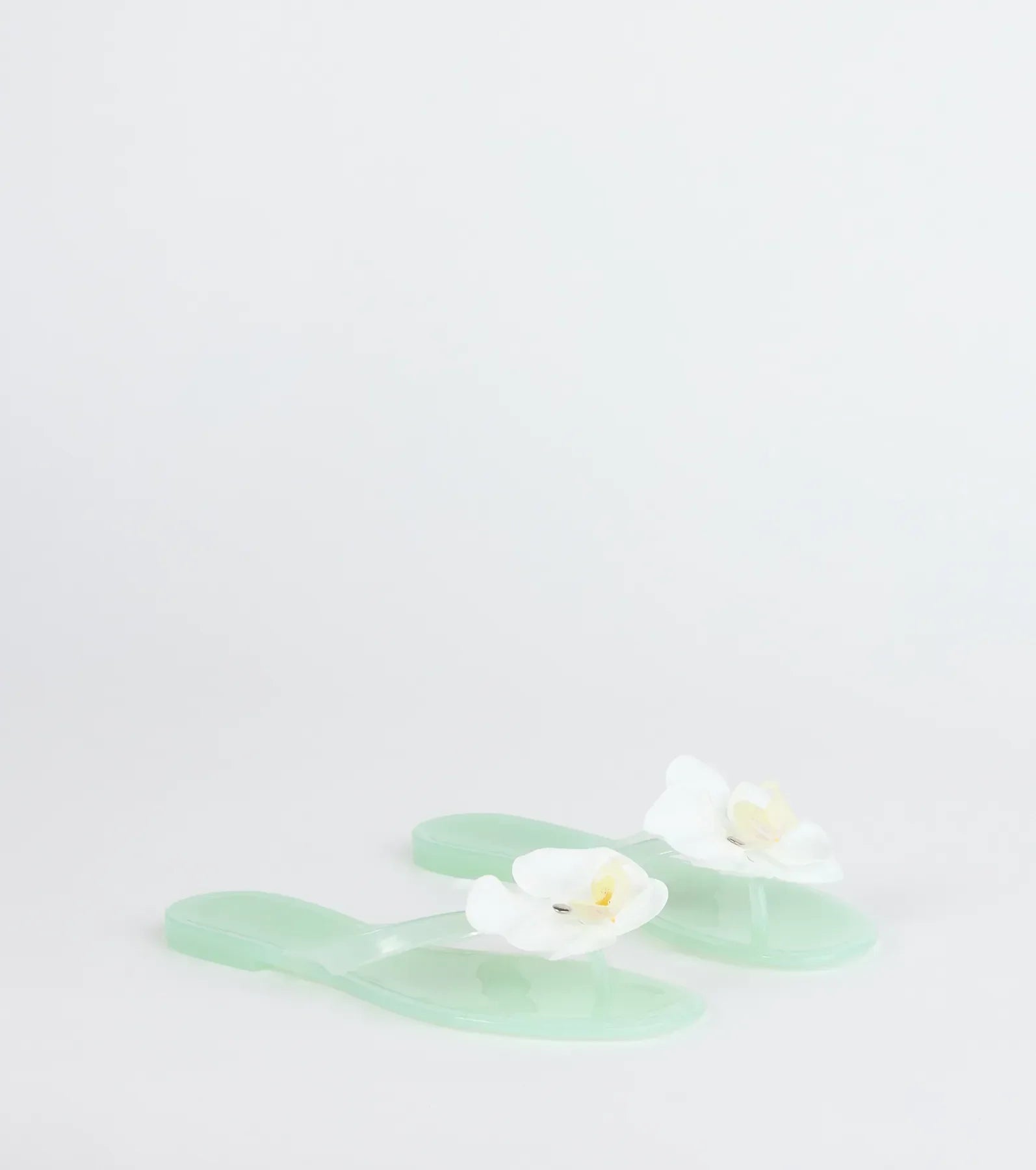 Style made simple with the On Vacay Flower Strap Jelly Sandals in mint green, trendy women’s shoes that take your outfit from basic to bold in one step.