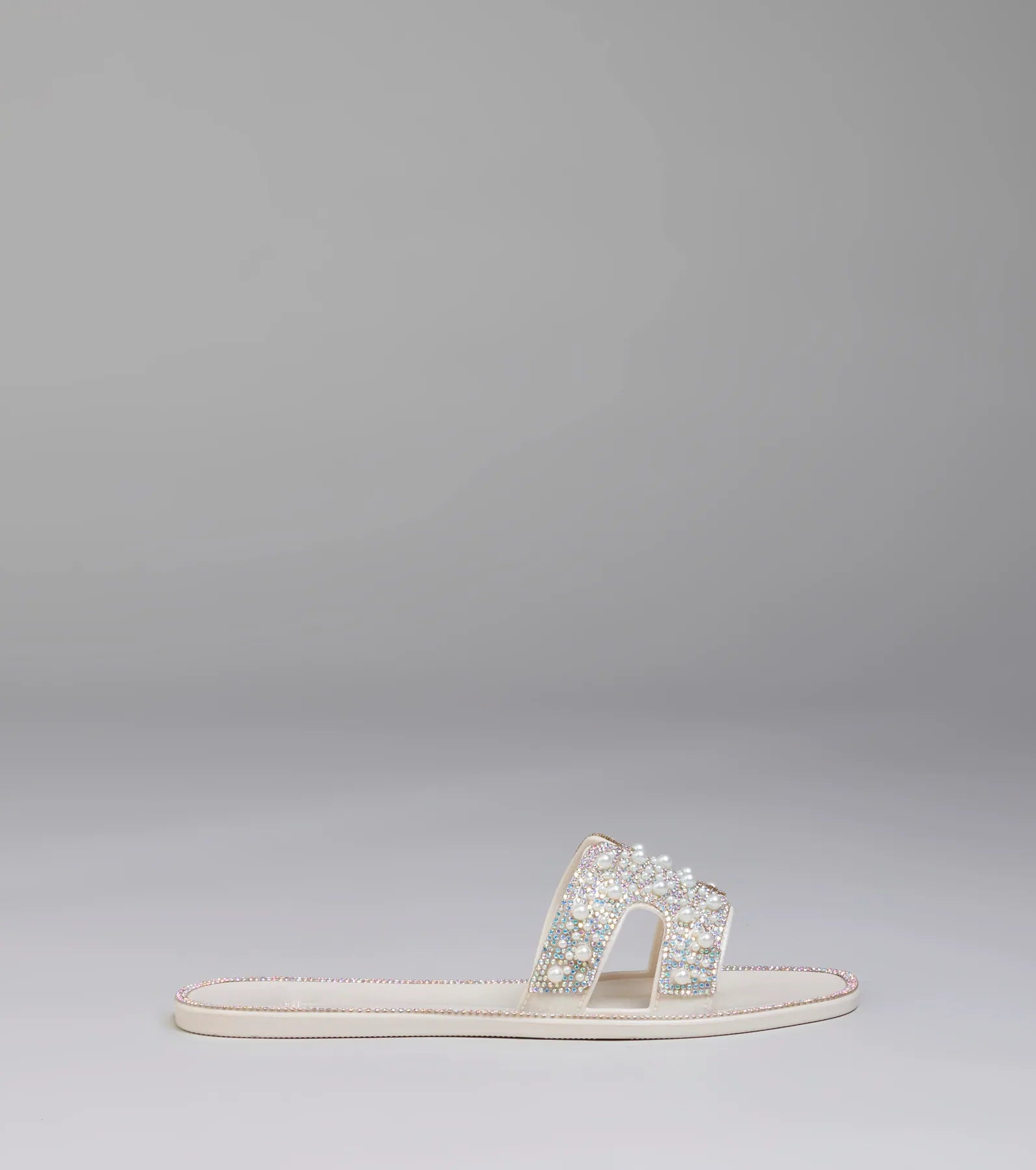 Elevate warm-weather looks with Pop Of Luxe Sparkle Faux Pearl Rhinestone Sandals in ivory, a pair of trendy sandals bringing chic, modern flair to every step.