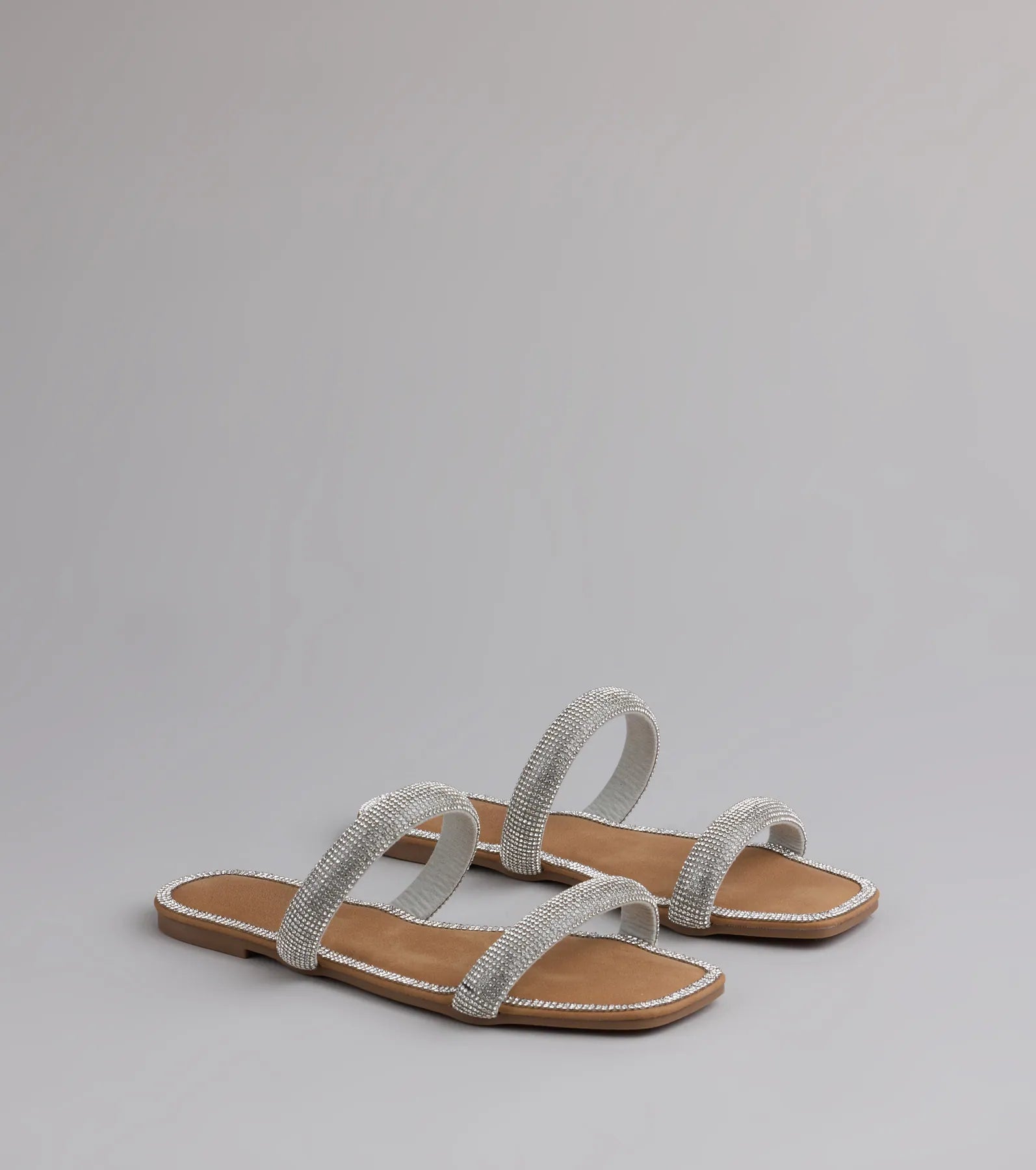Style made simple with the Step Into Glam Rhinestone Sandals in silver, trendy women’s shoes that take your outfit from basic to bold in one step.