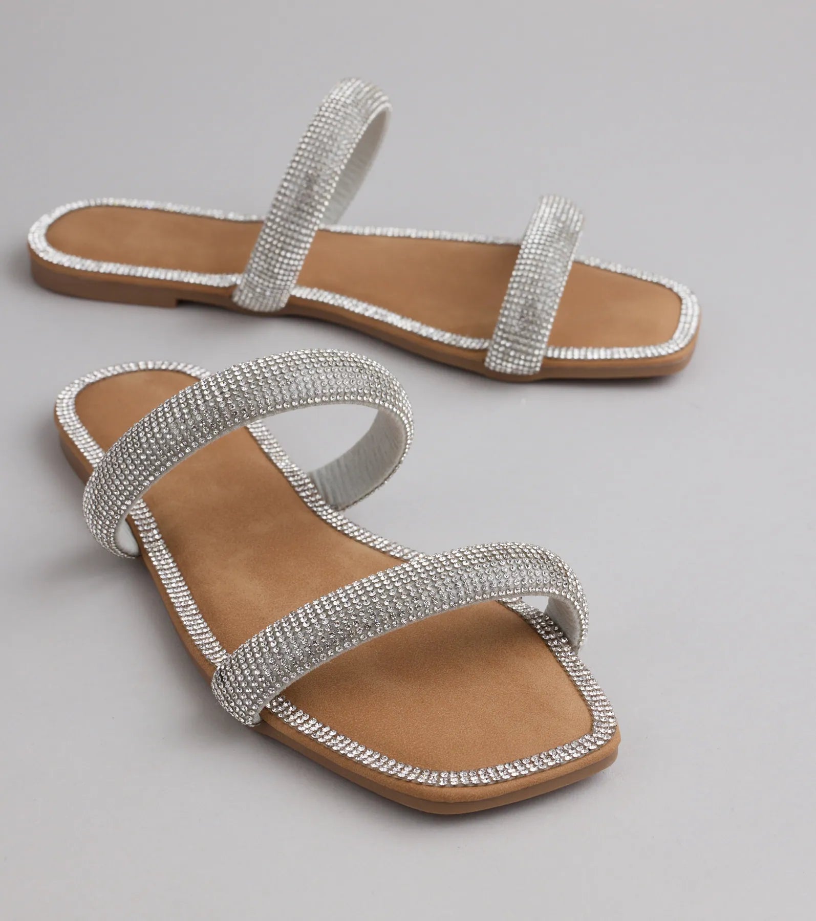 Style made simple with the Step Into Glam Rhinestone Sandals in silver, trendy women’s shoes that take your outfit from basic to bold in one step.