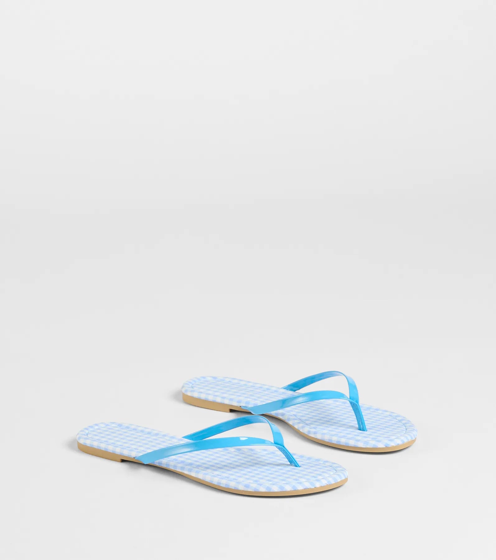 Style made simple with the Cutie Vibe Gingham Print Thong Strap Sandals in blue, trendy women’s shoes that take your outfit from basic to bold in one step.