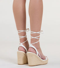 Elevate warm-weather looks with Coastal Weekend Lace-Up Espadrille Wedges in white, a pair of trendy sandals bringing chic, modern flair to every step.