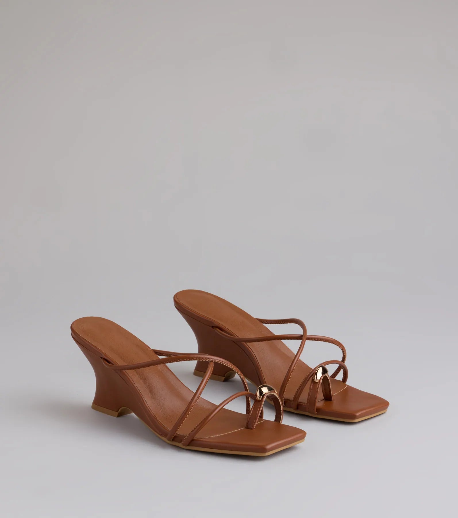 Style made simple with the Refined And Classy Toe Ring Strappy Wedges in tan, trendy women’s shoes that take your outfit from basic to bold in one step.